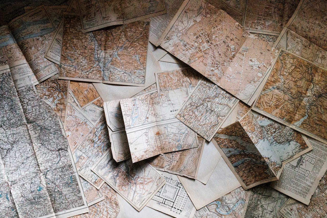 Mastering the First Impression: Your intriguing post title goes here A collection of vintage maps scattered for exploring world journeys and discoveries.